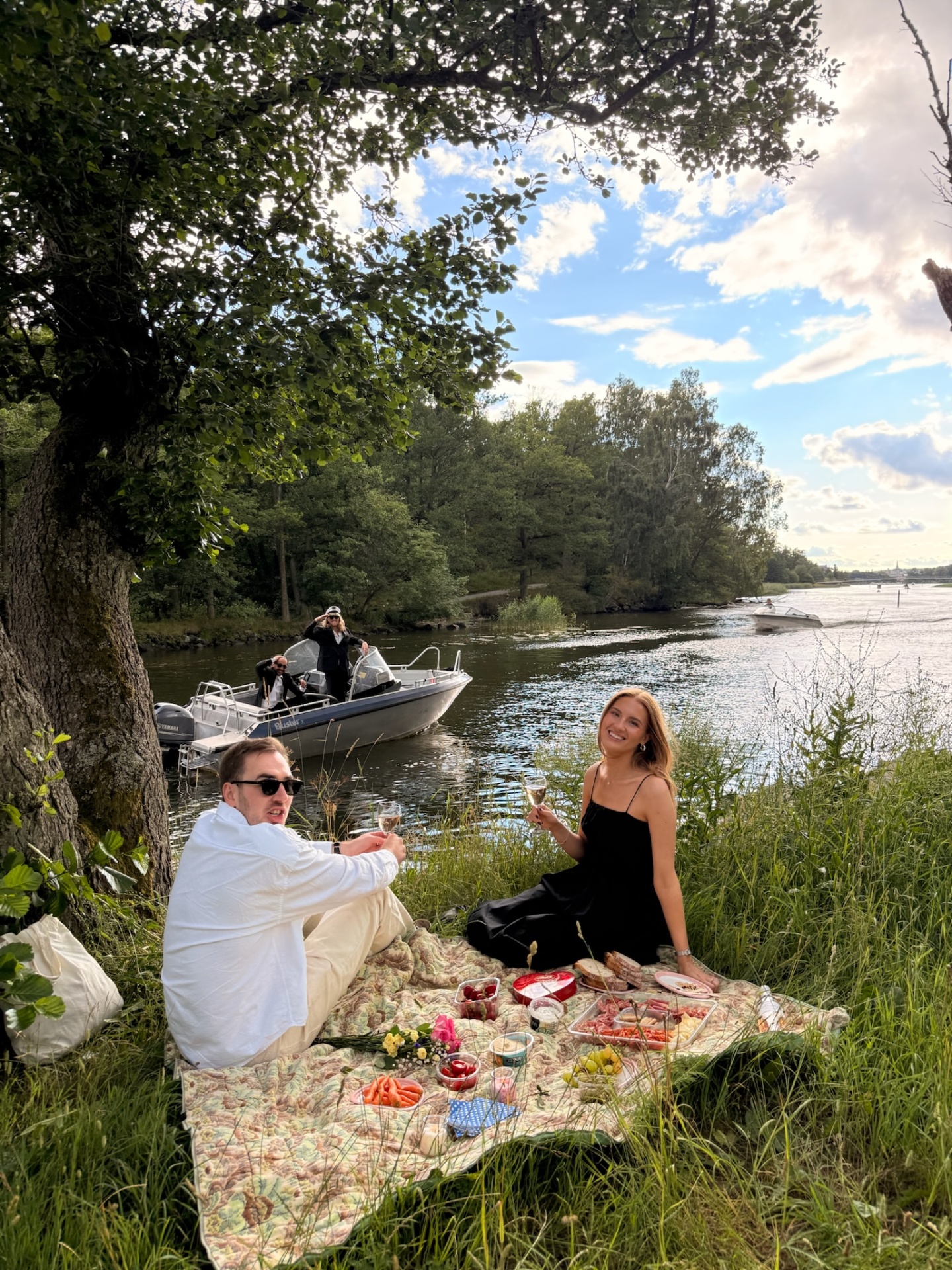 Sunset picnic by the water with the boat moored